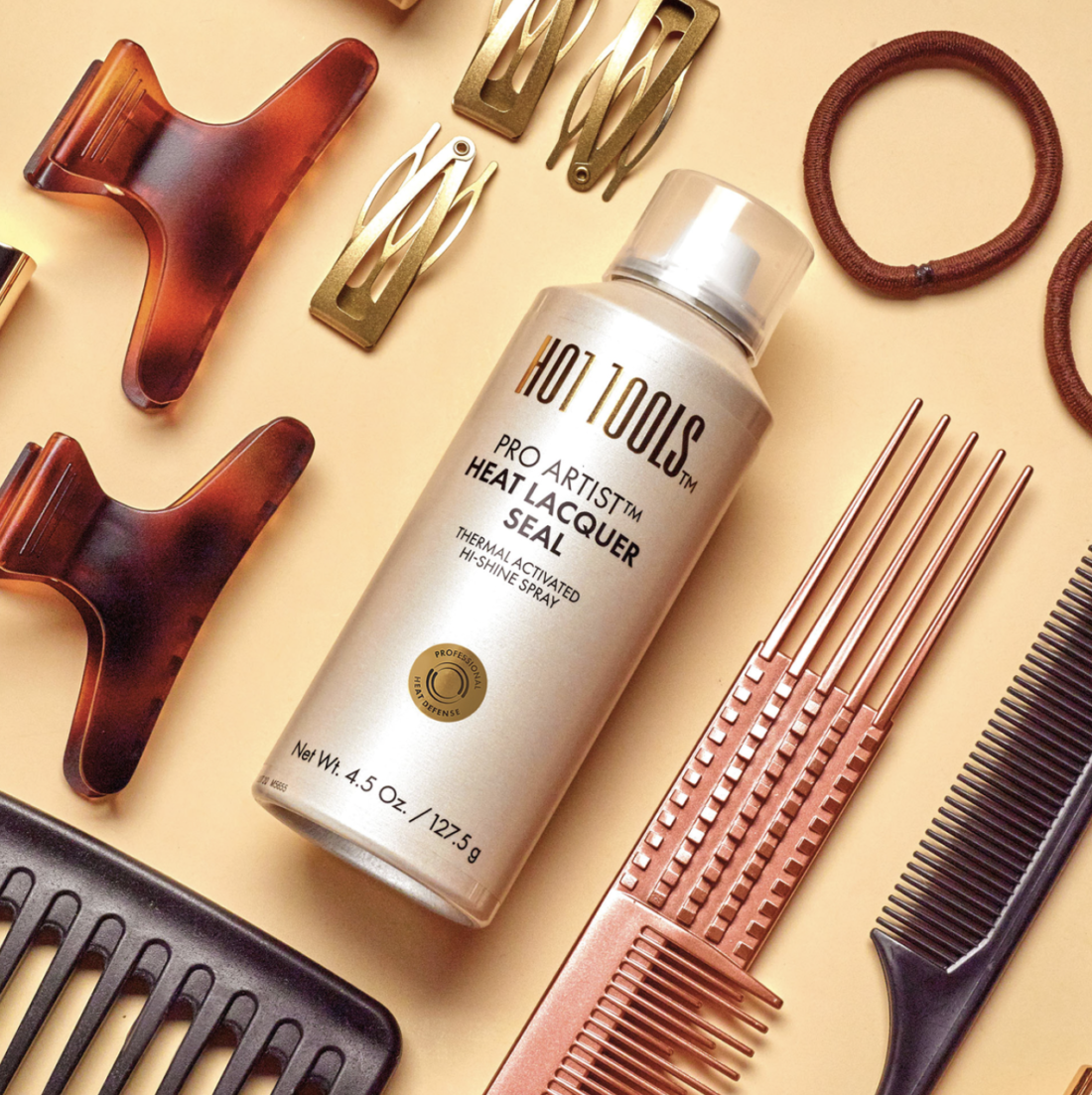 Botellas de la línea de protectores térmicos Hot Tools sobre una superficie minimalista, destacando productos para hidratar, reparar y proteger el cabello del daño por calor durante la temporada de frío.